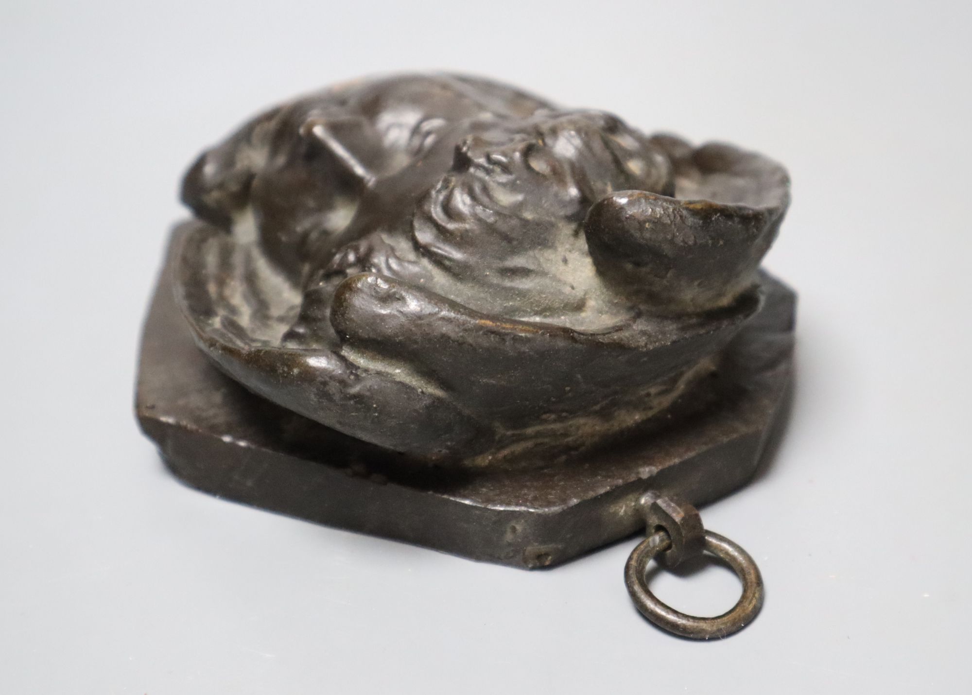 A bronze relief of a cherub, length 13cm
